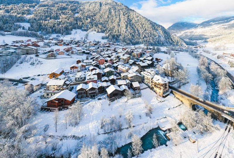 A birds eye view of a hamlet covered in snow