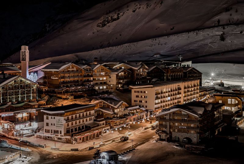 A bird's eye view at night of the purpose-build resort village of Tignes under snow