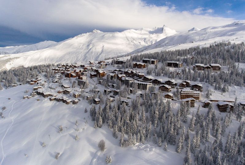 Village of La Rosiere spreads across a snowy slope, the photo taken from above