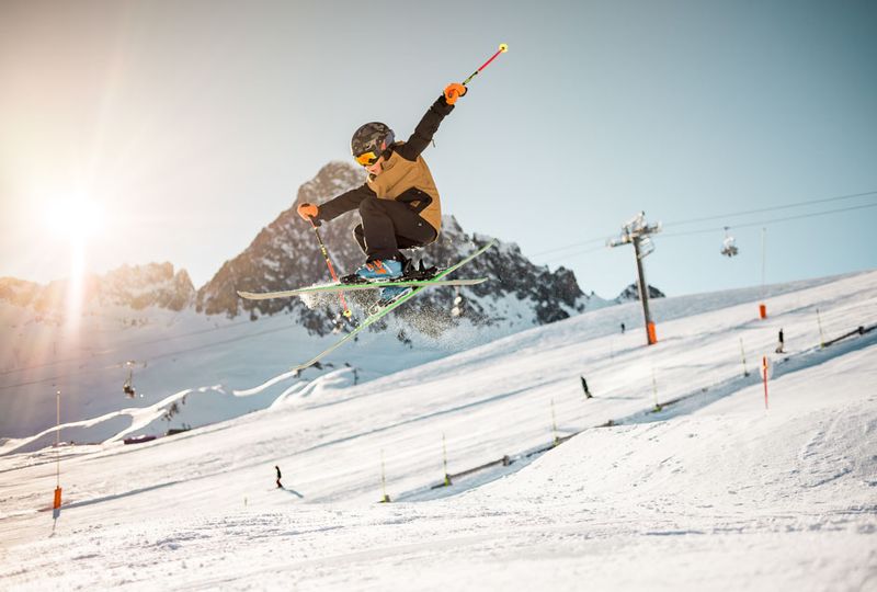 A young skier takes big air off a jump